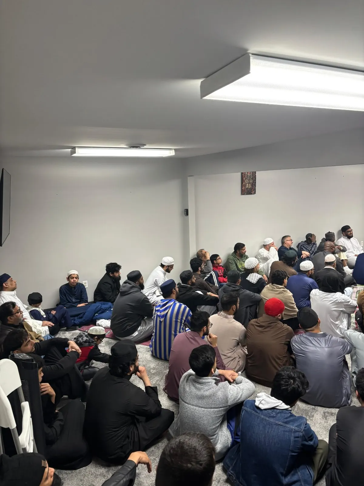 The community seated for the Friday khutbah