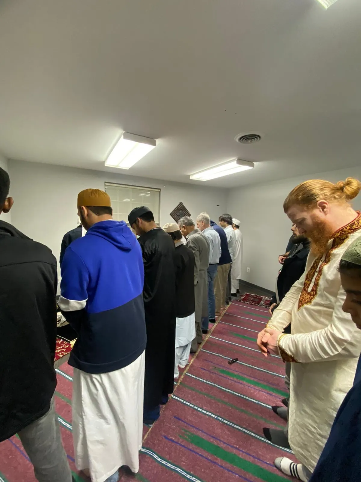 Brothers standing shoulder to shoulder for congregational prayer