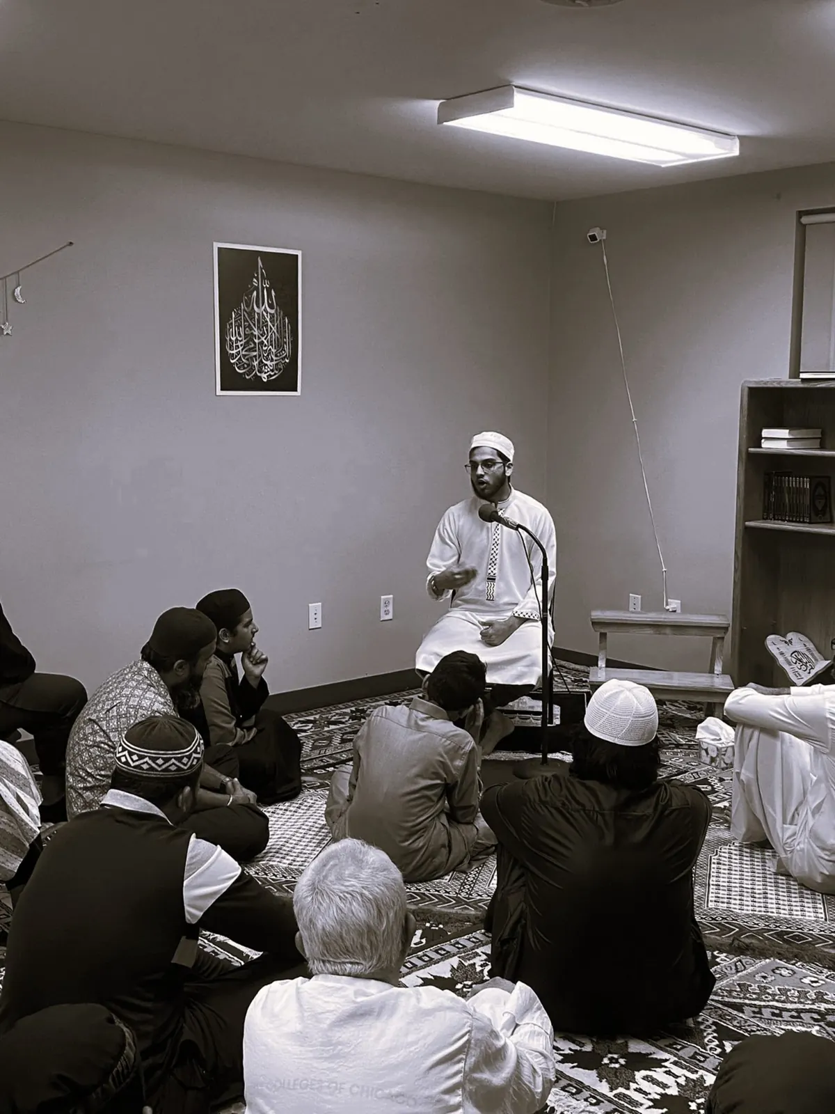A gathering listening to a talk at the musallah